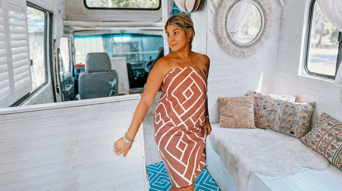 Woman wrapped in a Newlyfe waffle-weave bath towel inside a campervan
